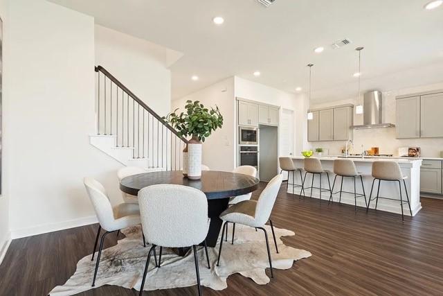 dining area with dark hardwood / wood-style floors and sink