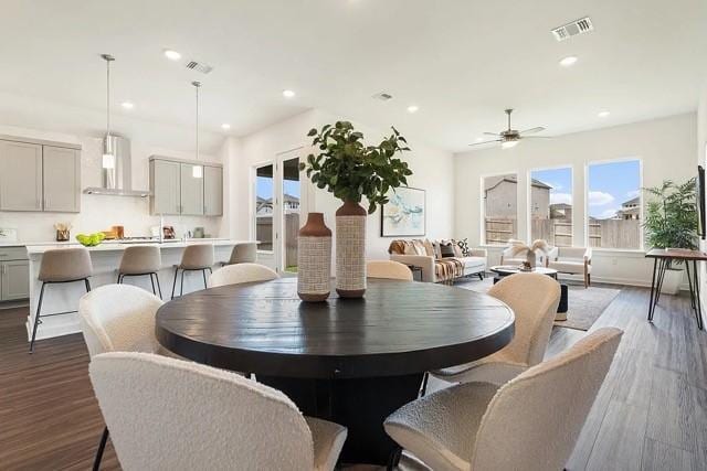 dining room with dark wood-type flooring and ceiling fan