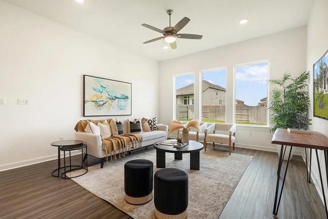 living room with ceiling fan and dark hardwood / wood-style flooring