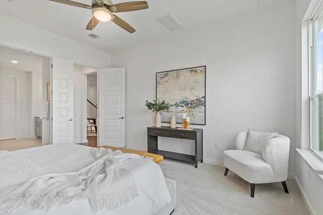 carpeted bedroom featuring ceiling fan