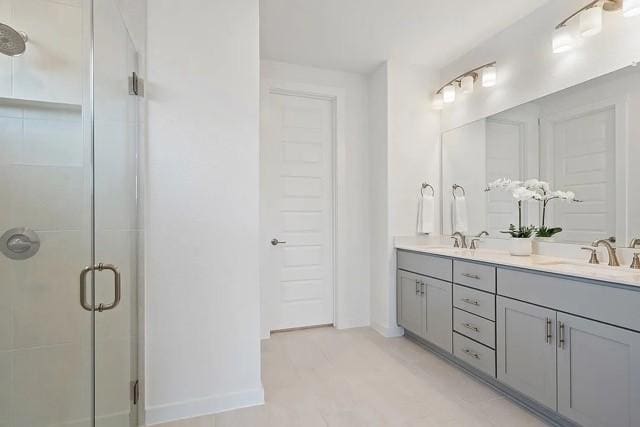 bathroom with a shower with door and vanity