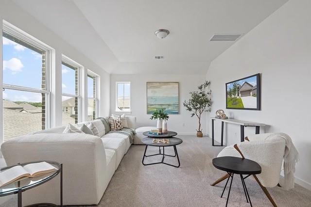 living room featuring lofted ceiling and light colored carpet