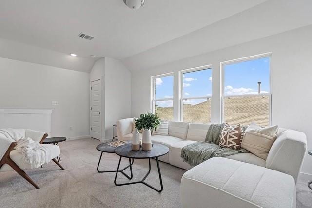 living room with lofted ceiling and light colored carpet