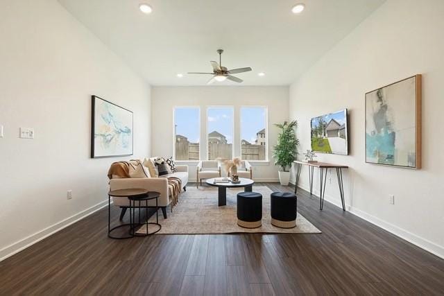 living room with dark hardwood / wood-style flooring and ceiling fan