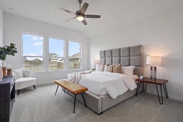 bedroom featuring lofted ceiling, light colored carpet, and ceiling fan