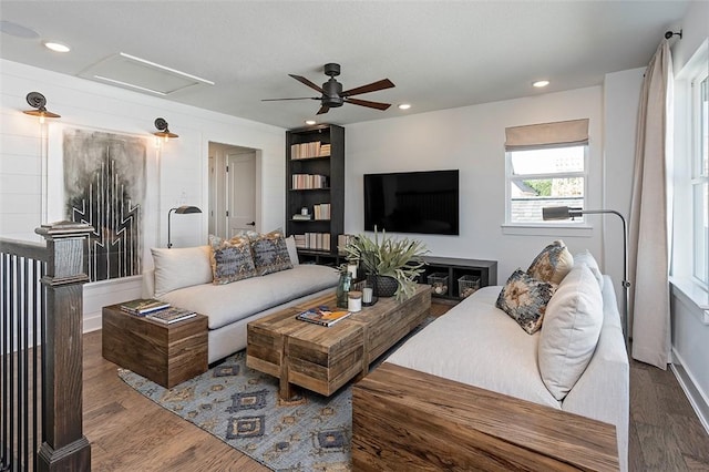 living room featuring wood-type flooring and ceiling fan