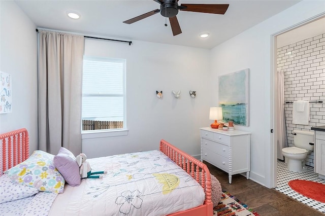 bedroom with recessed lighting, a ceiling fan, ensuite bath, and dark wood-style floors