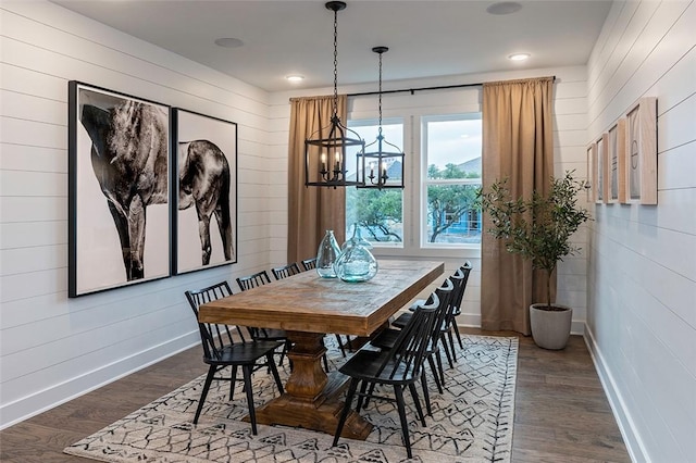 dining area featuring an inviting chandelier and dark hardwood / wood-style flooring