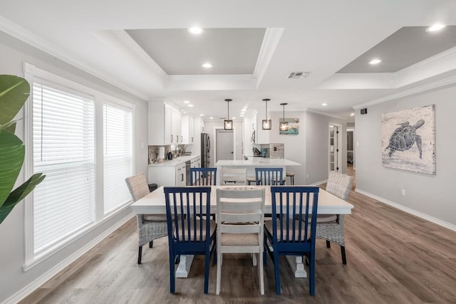 13569 Bullion Ct, Corpus Christi, TX 78418 - dining area with a raised ceiling, light wood finished floors, ornamental molding, and recessed lighting