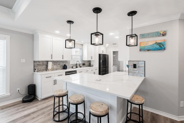 13569 Bullion Ct, Corpus Christi, TX 78418 - kitchen featuring fridge with ice dispenser, a kitchen breakfast bar, light wood finished floors, decorative backsplash, and white cabinetry