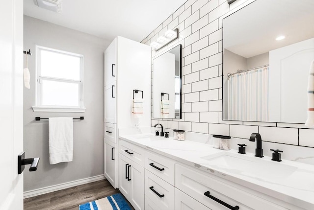 bathroom featuring vanity, backsplash, hardwood / wood-style floors, and tile walls