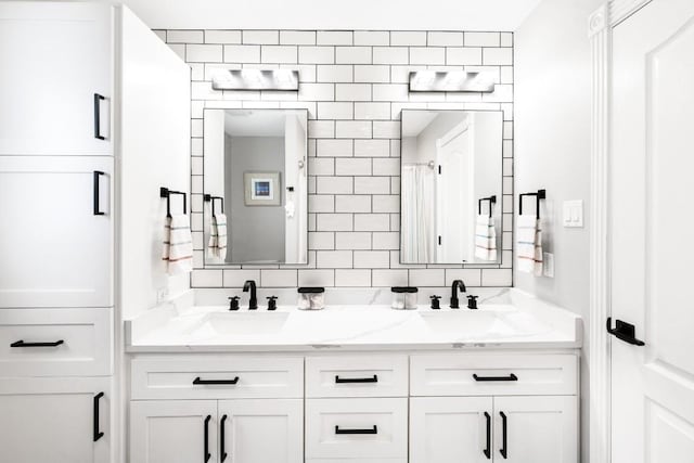 bathroom with tasteful backsplash and vanity