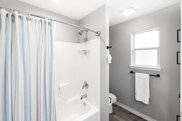 13569 Bullion Ct, Corpus Christi, TX 78418 - bathroom with shower / bathtub combination with curtain and wood finished floors