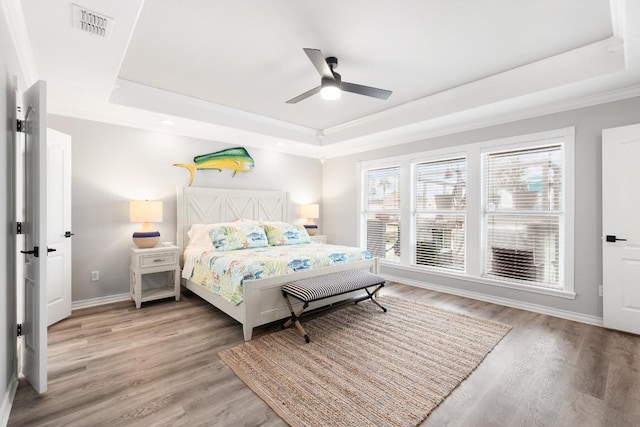 13569 Bullion Ct, Corpus Christi, TX 78418 - bedroom with a raised ceiling, light wood-type flooring, ornamental molding, and a ceiling fan