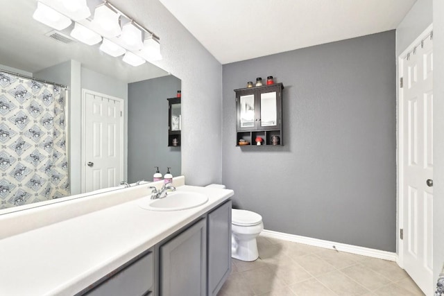 bathroom with visible vents, baseboards, toilet, tile patterned floors, and vanity