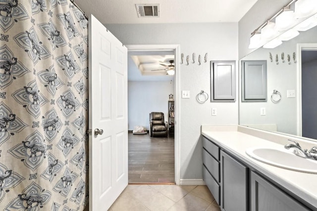 full bath with baseboards, visible vents, a ceiling fan, tile patterned floors, and vanity