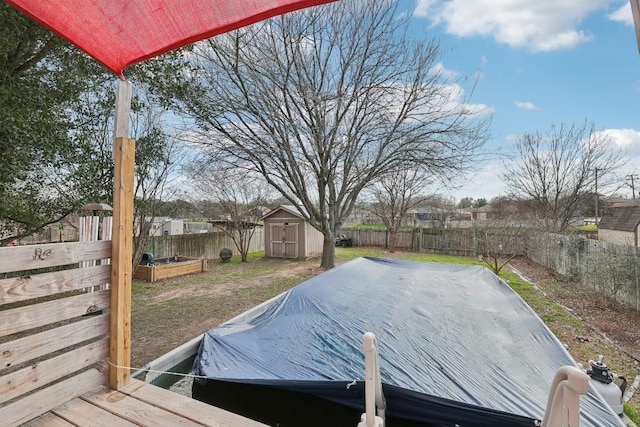 exterior space with a storage shed, an outdoor structure, a fenced backyard, and a garden