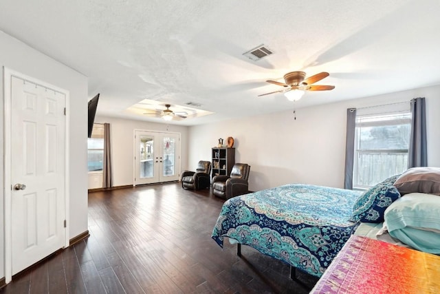 bedroom with dark wood-style floors, french doors, visible vents, access to outside, and multiple windows