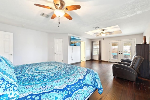 bedroom with access to outside, visible vents, a tray ceiling, and french doors