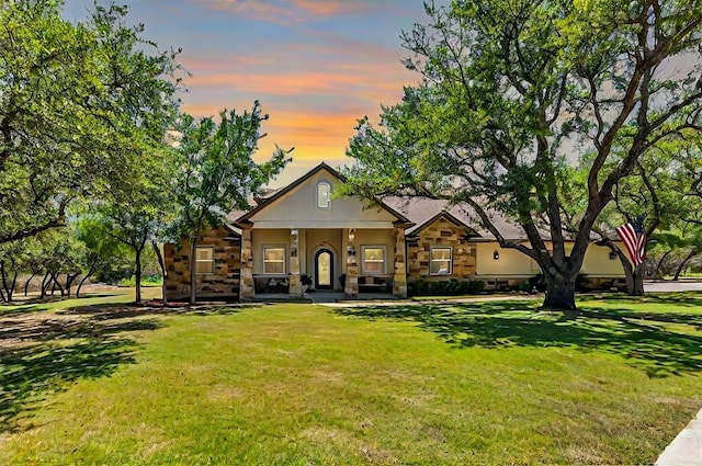 view of front of property featuring a yard and stucco siding