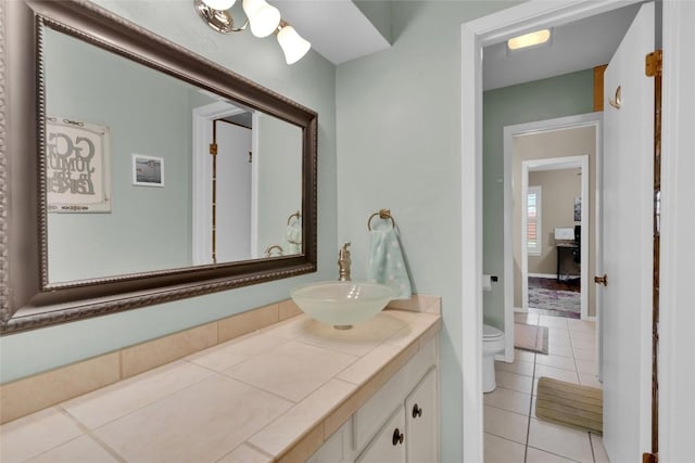 bathroom with vanity, tile patterned floors, and toilet