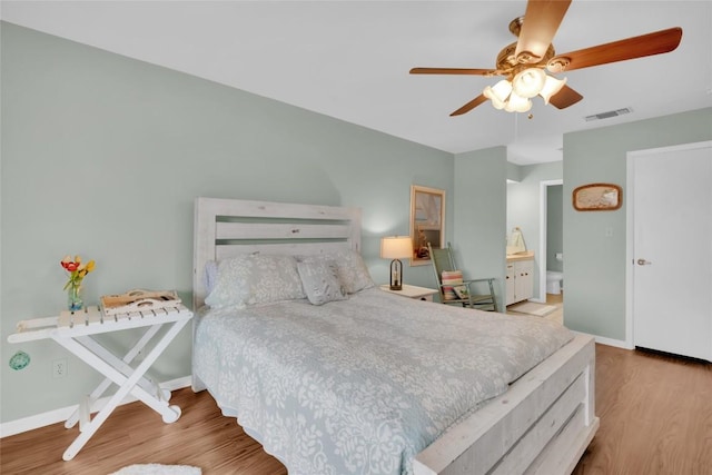 bedroom with light hardwood / wood-style floors, ceiling fan, and ensuite bathroom