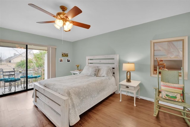 bedroom featuring access to exterior, hardwood / wood-style flooring, and ceiling fan