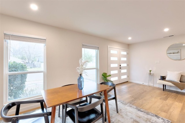 dining room with french doors and hardwood / wood-style floors