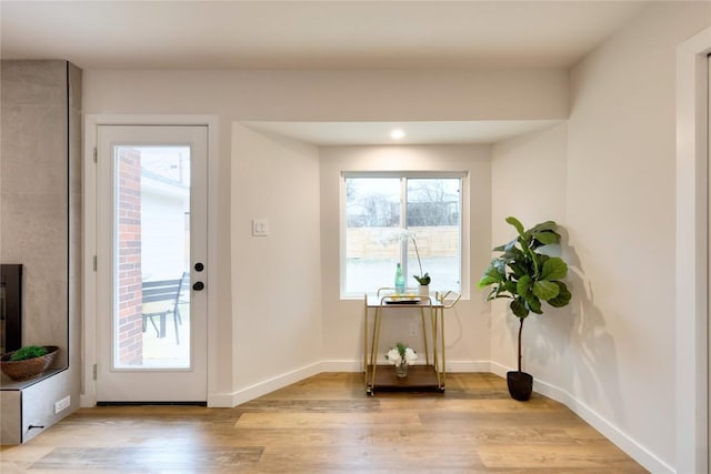 doorway to outside with light wood-type flooring