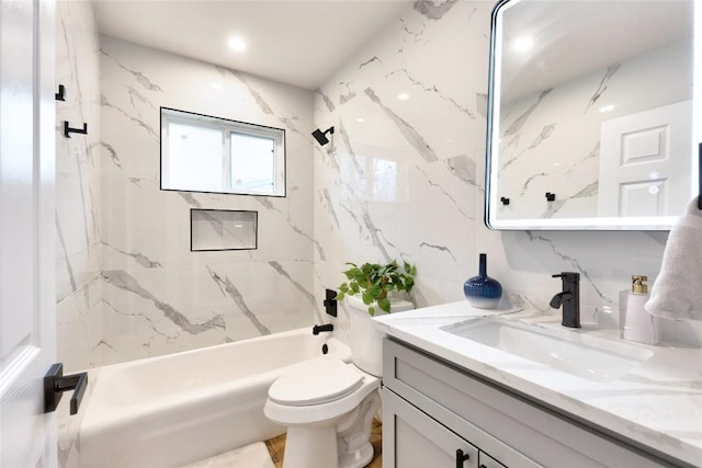 full bathroom with tile walls, toilet, vanity, and tiled shower / bath combo