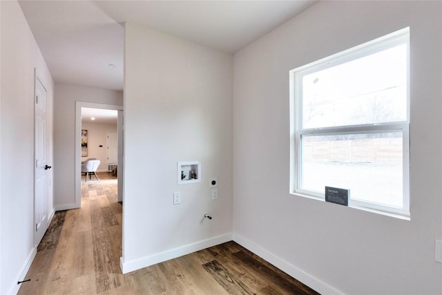 laundry room with hardwood / wood-style flooring, hookup for an electric dryer, and hookup for a washing machine