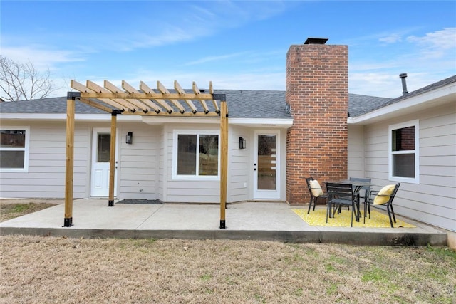 rear view of house featuring a pergola, a lawn, and a patio area