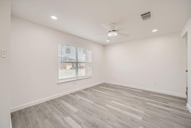 spare room with light hardwood / wood-style flooring and ceiling fan