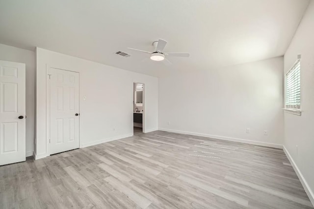 unfurnished bedroom featuring ceiling fan, connected bathroom, and light hardwood / wood-style floors