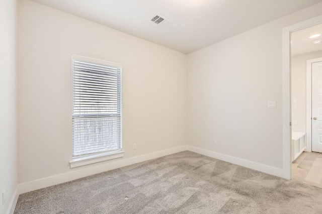 empty room featuring light carpet