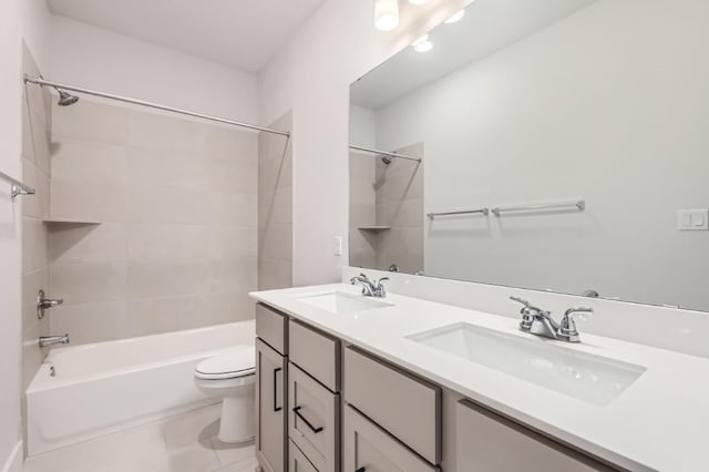 full bathroom with tile patterned flooring, vanity, toilet, and tiled shower / bath