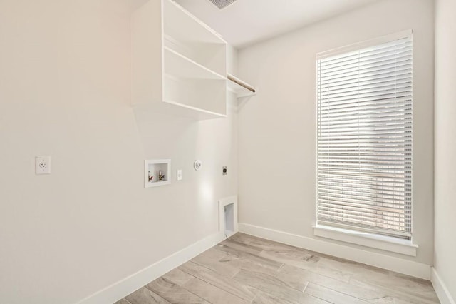 washroom with electric dryer hookup, washer hookup, light hardwood / wood-style floors, and gas dryer hookup