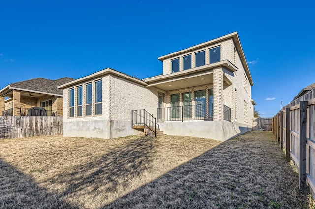 155 Cyrus Milton Dr, Buda, TX 78610 - back of property with brick siding and a fenced backyard