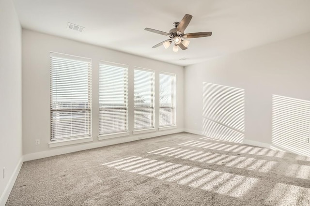 carpeted spare room with ceiling fan