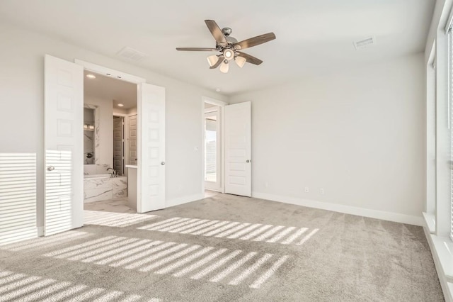 155 Cyrus Milton Dr, Buda, TX 78610 - unfurnished bedroom with carpet floors, baseboards, and connected bathroom