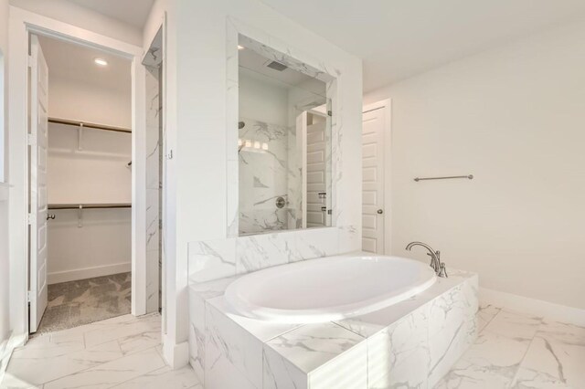 155 Cyrus Milton Dr, Buda, TX 78610 - bathroom with marble finish flooring, a garden tub, a walk in closet, and a marble finish shower