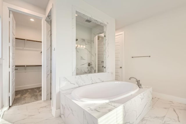 155 Cyrus Milton Dr, Buda, TX 78610 - full bath with marble look tiles, a bath, a walk in closet, and a marble finish shower
