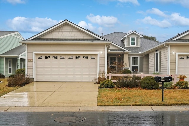 craftsman-style house featuring a garage, roof with shingles, and driveway