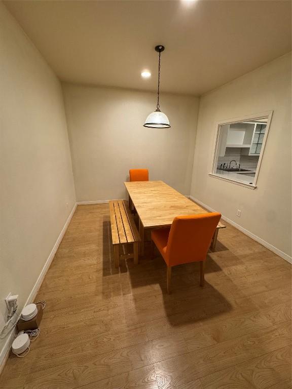 dining area with sink and hardwood / wood-style floors