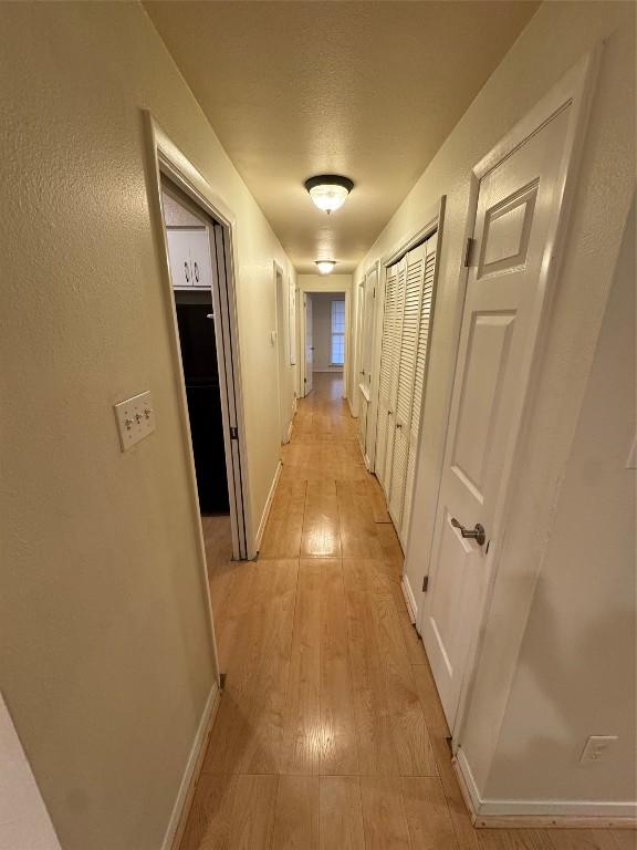 hall with light hardwood / wood-style floors