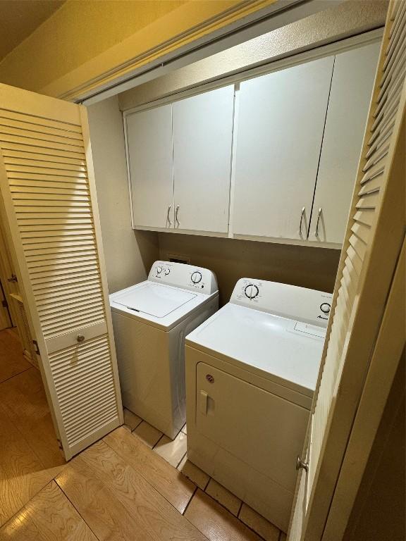 washroom with cabinets and independent washer and dryer