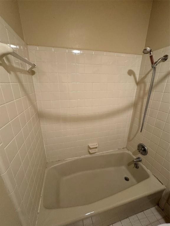 bathroom featuring tile patterned flooring and tiled shower / bath