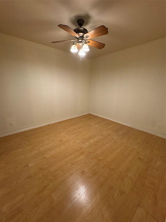 empty room with light hardwood / wood-style floors and ceiling fan