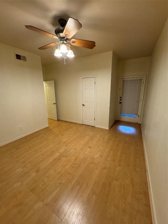 spare room with light hardwood / wood-style floors and ceiling fan