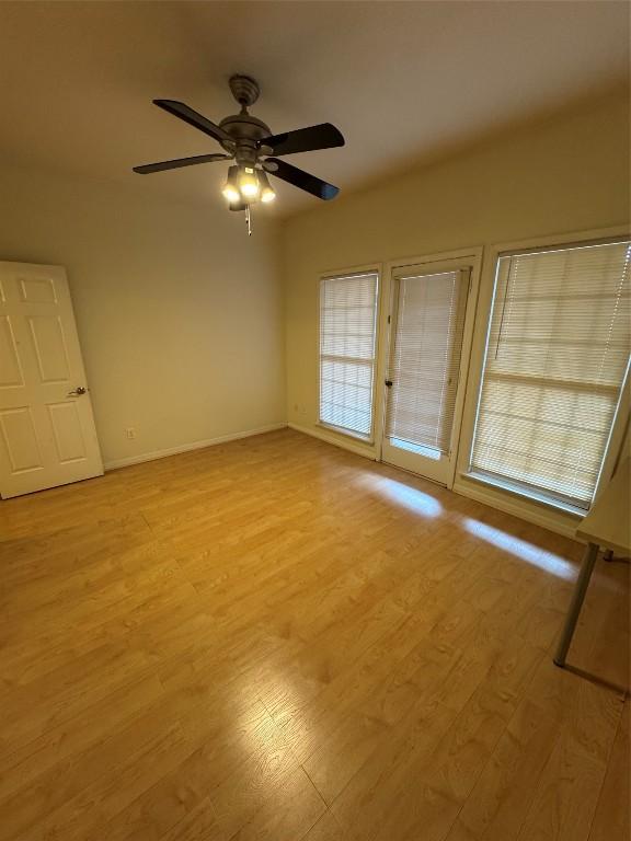 empty room featuring ceiling fan and light hardwood / wood-style floors